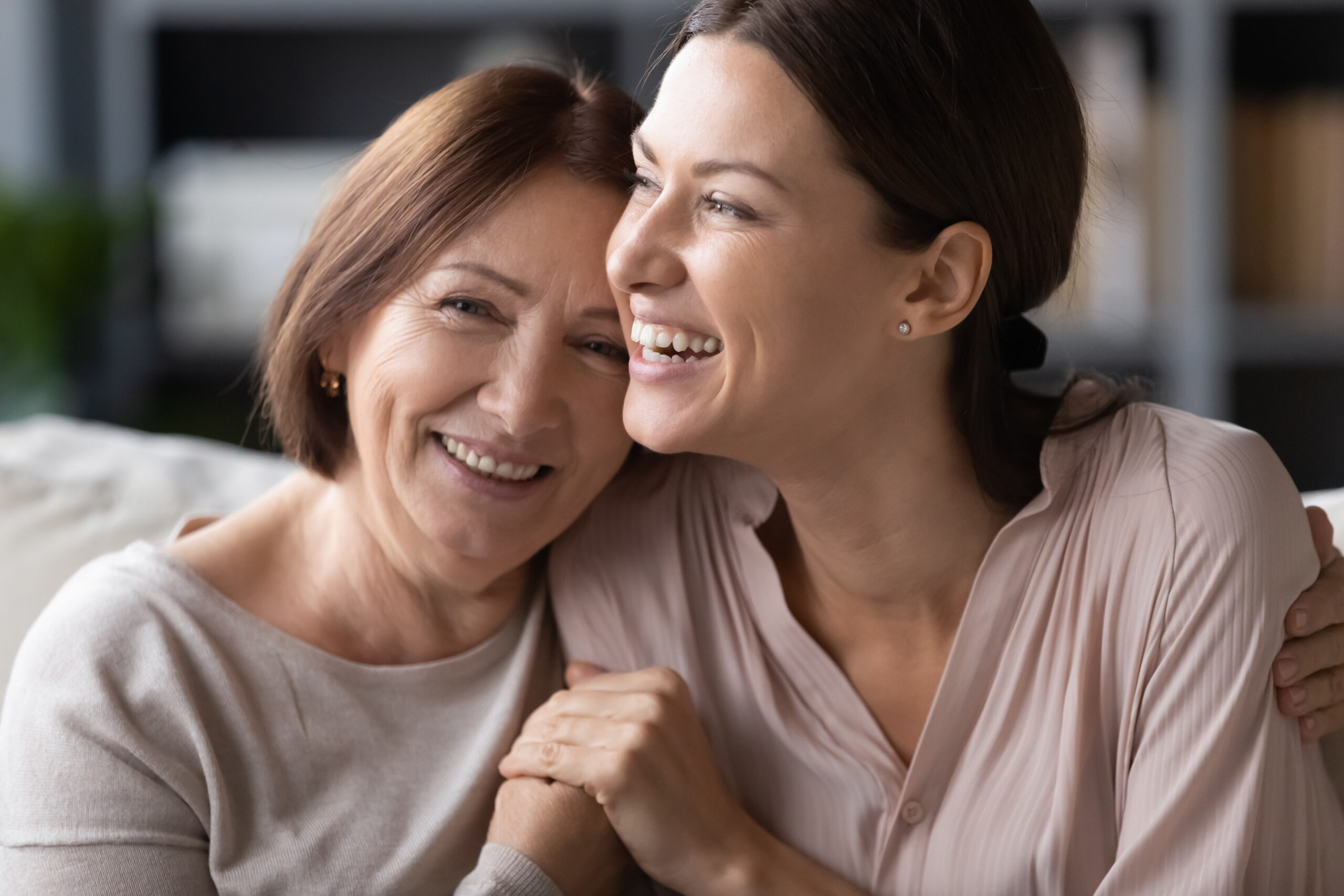 Mother and daughter smiling together.