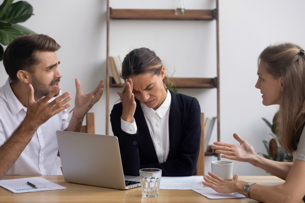 Landlord and tenant arguing in a meeting with solicitor.