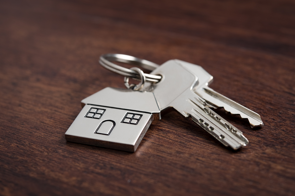 Silver keychain with a house and two keys